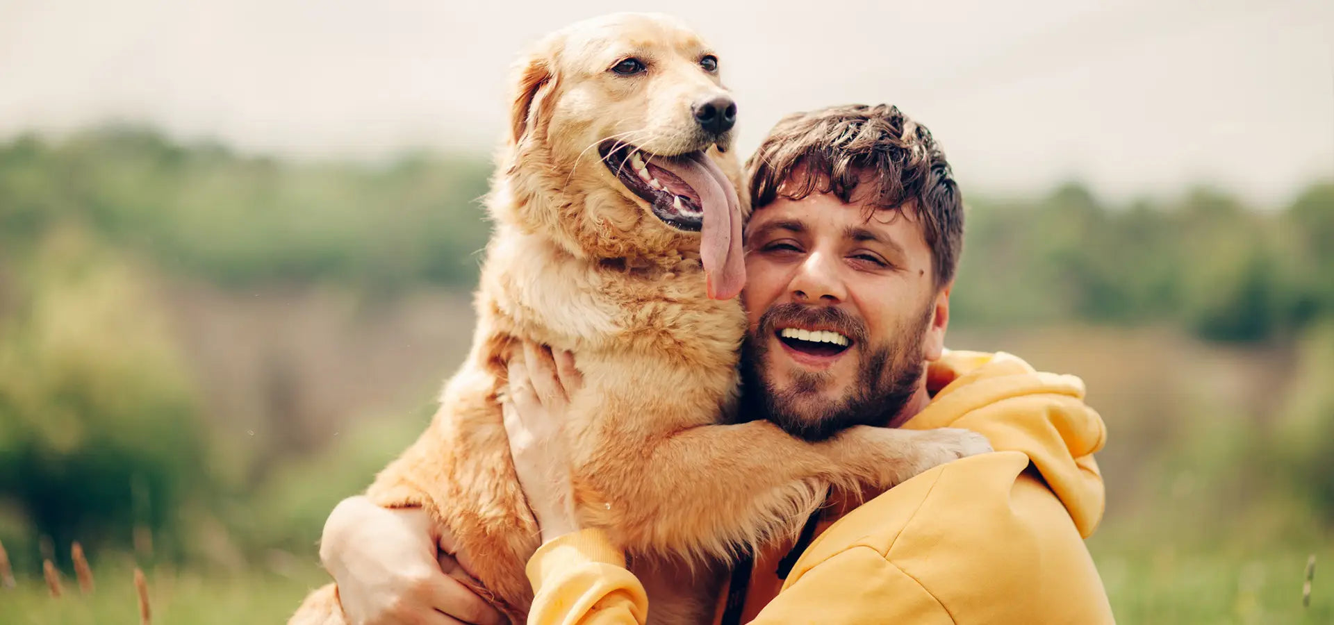 Man Hugging Golden Retriever